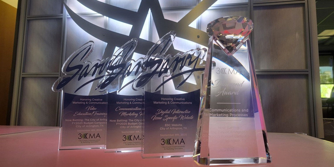 Trophies in front of Arlington logo