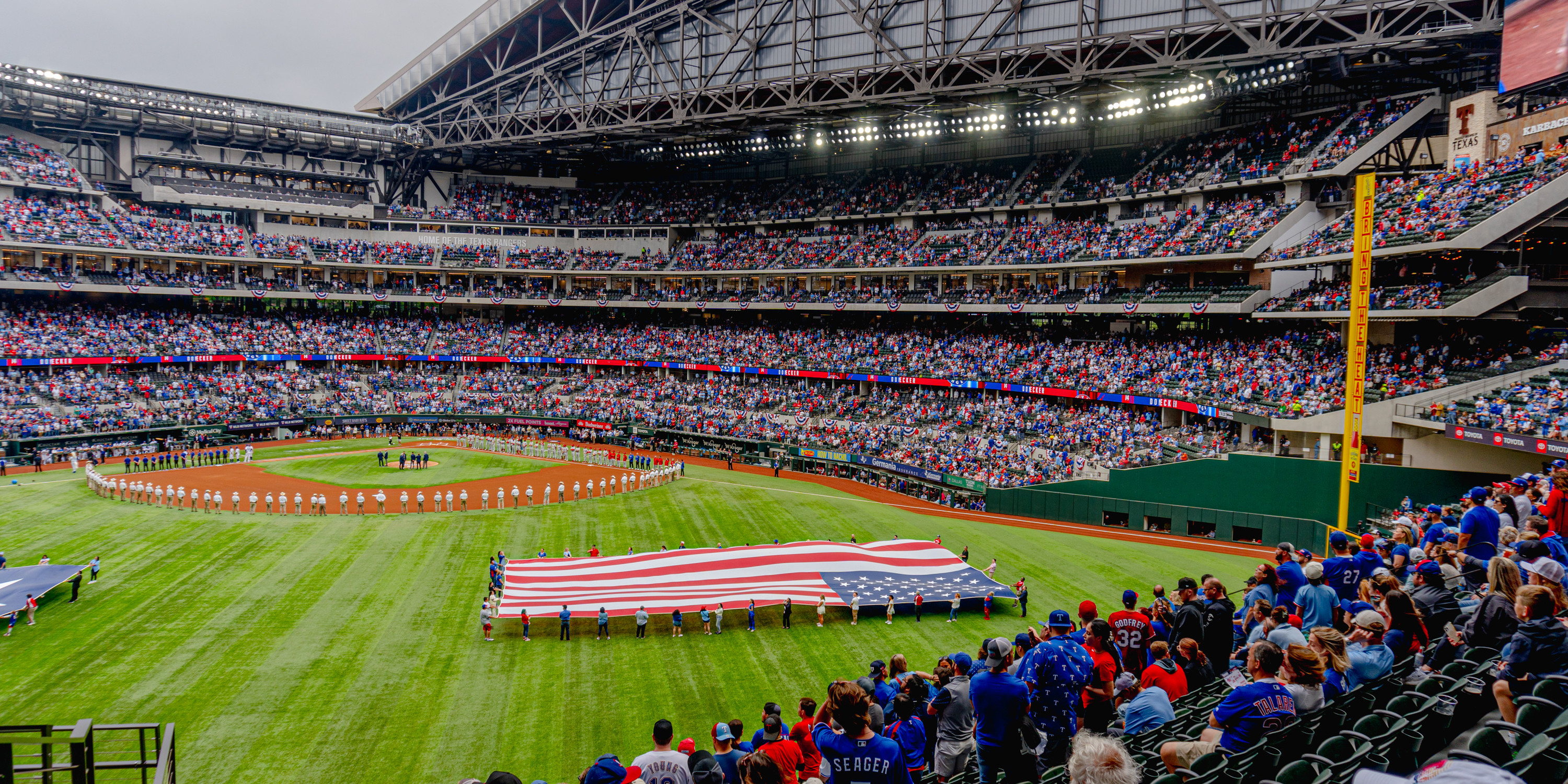 Baseball game at Globe Life Field with American flag presented on field